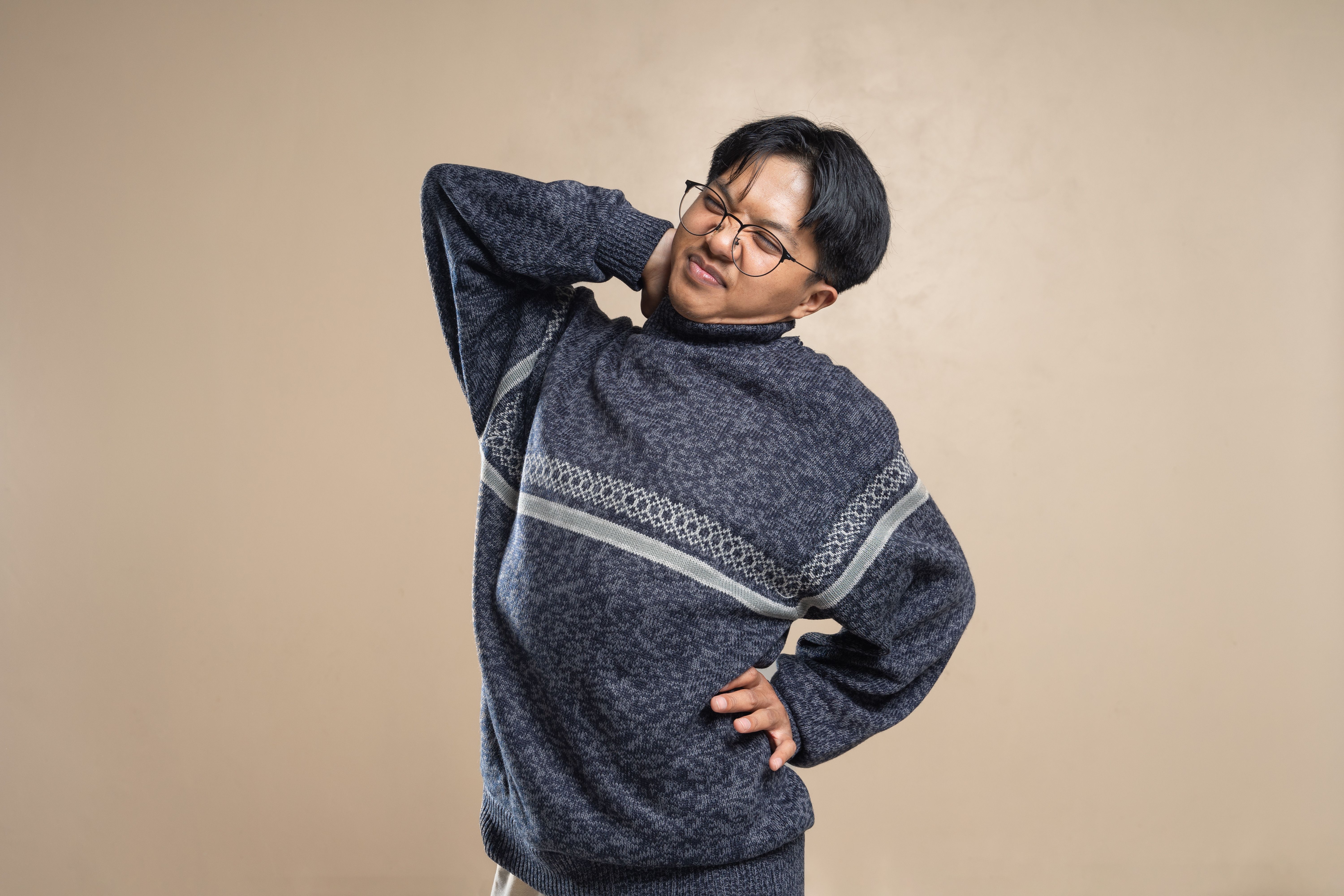 首の後ろを押さえて姿勢を気にしている様子